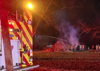 Flames engulf storage building in local neighborhood