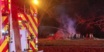 Flames engulf storage building in local neighborhood