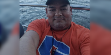 Huband, while in the same bed with his little daughter, tried to hug his wlfe two times before grabbing a hunting knife and stabbing the woman to death because she pushed him away twice, told police the attempted hugging was simply a test; charged