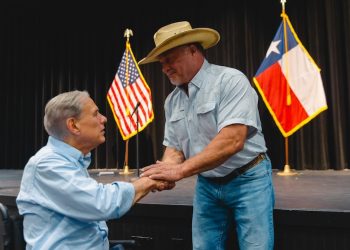 Governor Greg Abbott helps distribute flood relief funds to Hill Country families affected by catastrophic storms